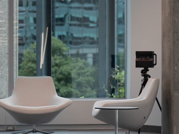 a room with a chair, a chair and a camera in it