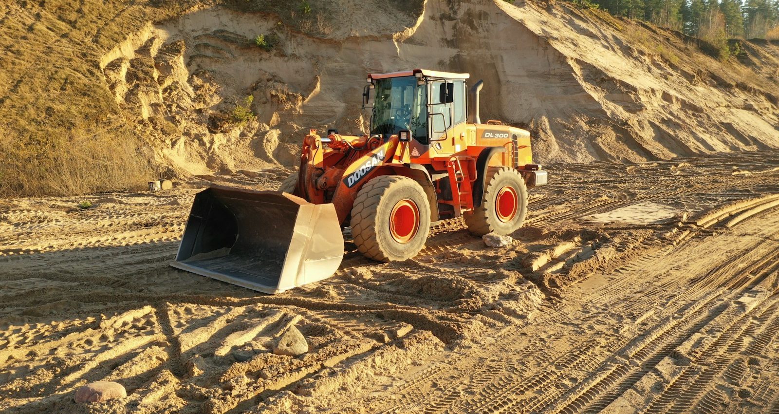 a bulldozer is parked on a dirt road