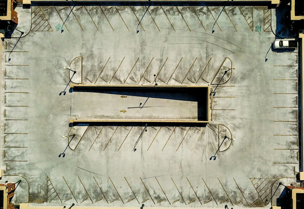 an aerial view of a parking lot with several empty benches