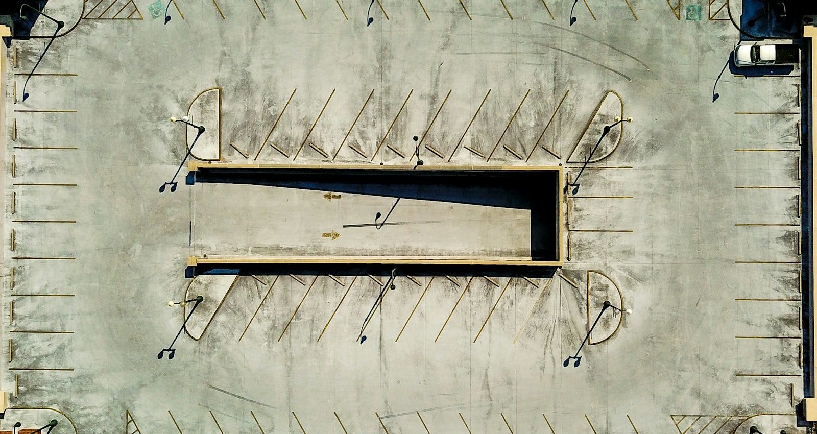 an aerial view of a parking lot with several empty benches