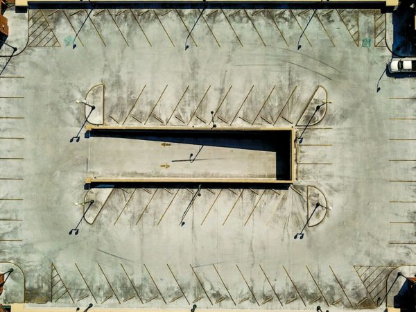 an aerial view of a parking lot with several empty benches
